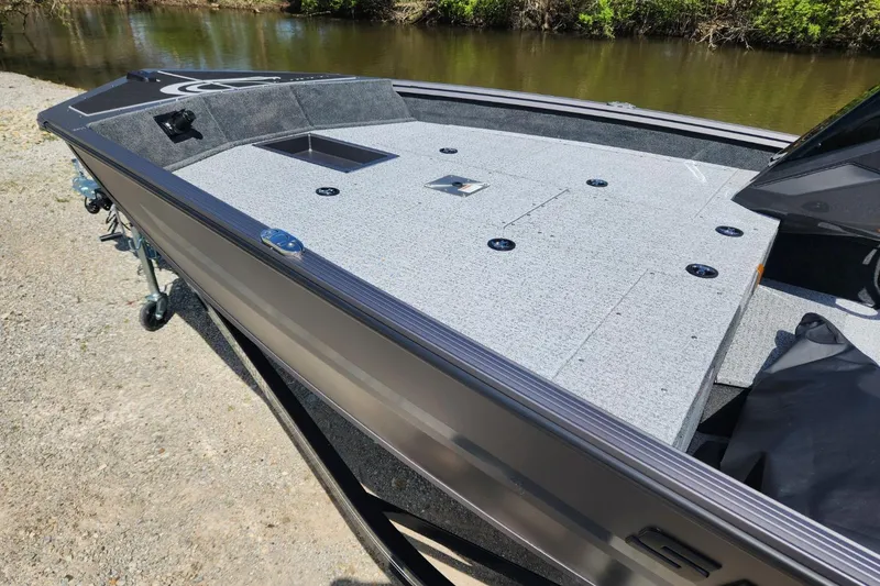 Slide: The Image of 2026 Smoker Craft Viper XR 175 Pro boat with spacious deck by a river. - 7