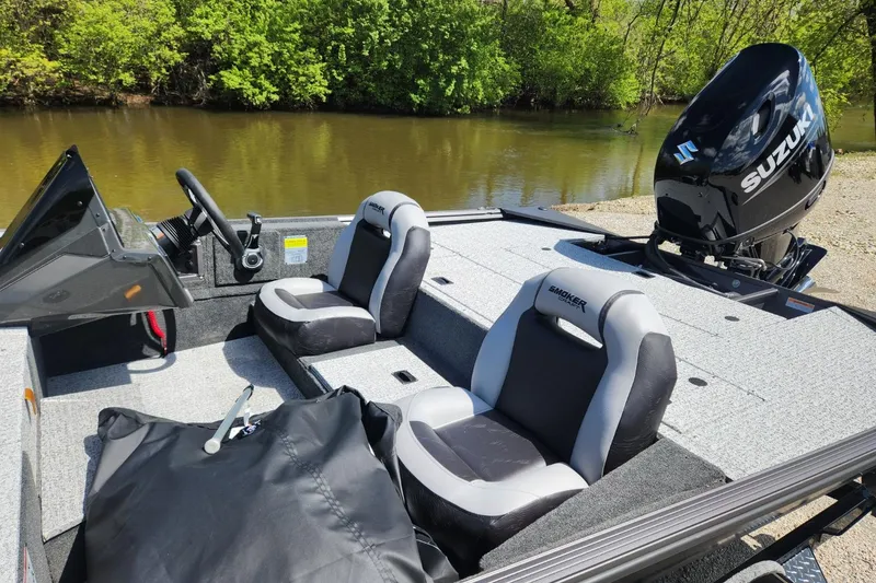 Slide: The Image of 2026 Smoker Craft Viper XR 175 Pro boat with Suzuki engine by a river. - 8