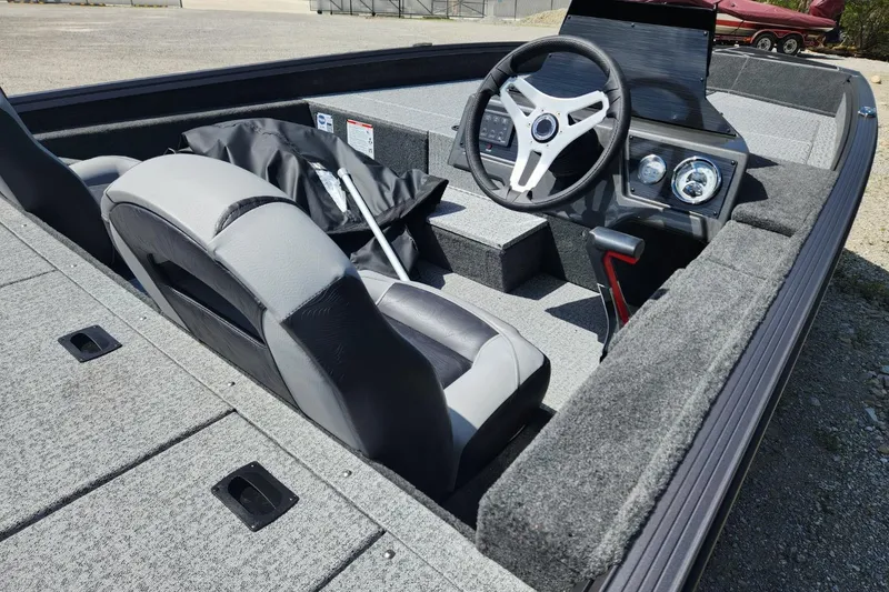 Slide: The Image of 2026 Smoker Craft Viper XR 175 Pro boat interior with steering wheel and seating. - 9