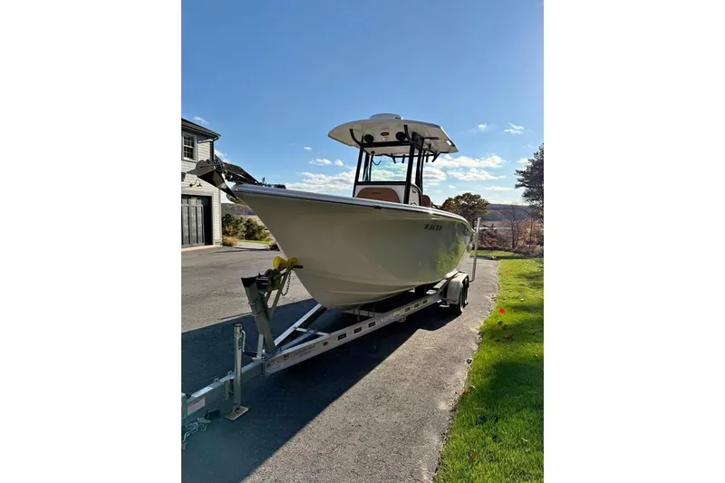 The Image of 2024 Sea Pro 242 Center Console boat on trailer, parked outdoors. - 1