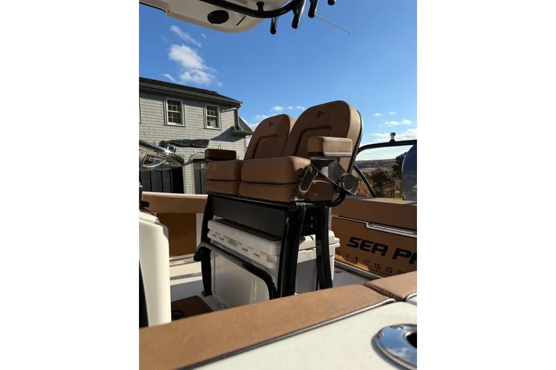 Slide: The Image of 2024 Sea Pro 242 Center Console boat interior with tan seating and storage. - 4