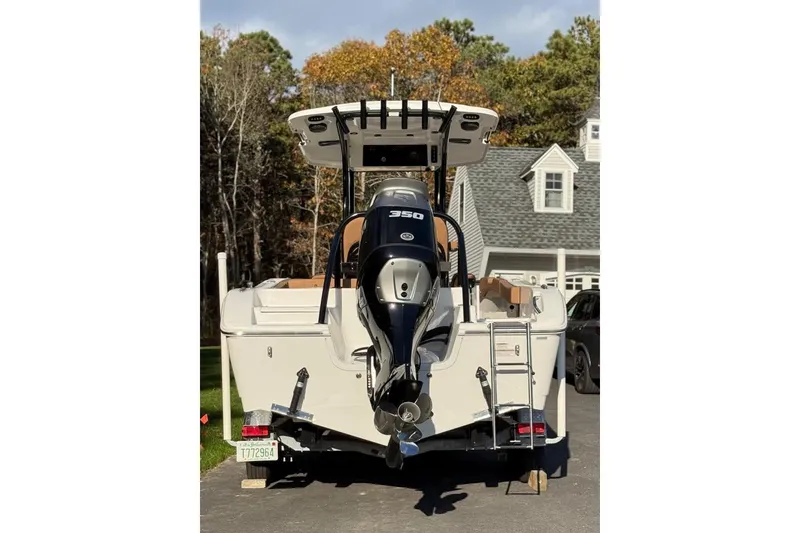 Slide: The Image of 2024 Sea Pro 242 Center Console boat with powerful outboard motor, parked in driveway. - 6