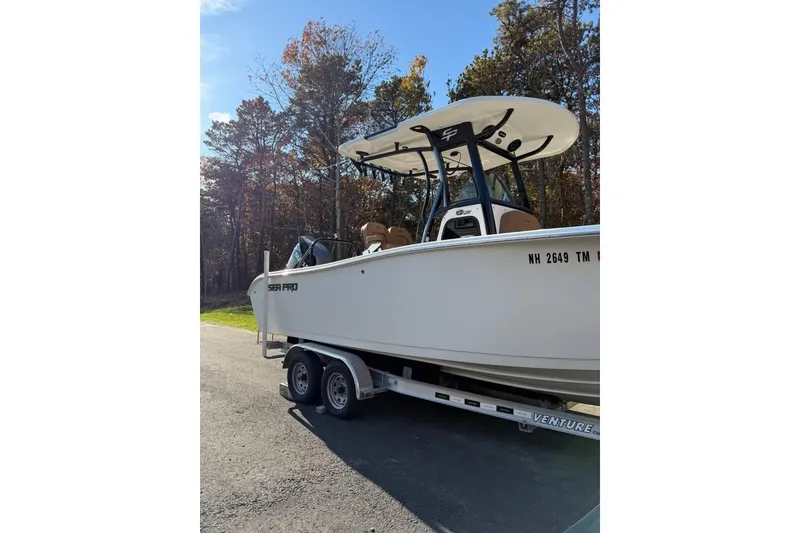 Slide: The Image of 2024 Sea Pro 242 Center Console boat on trailer, parked outdoors. - 7