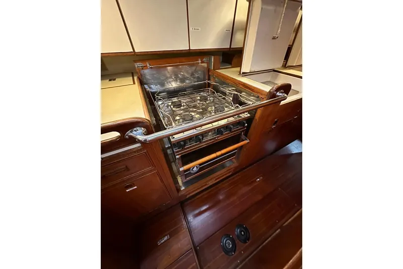 Slide: The Image of Galley kitchen in 1989 Hylas 44 yacht with stove and wooden cabinetry. - 10