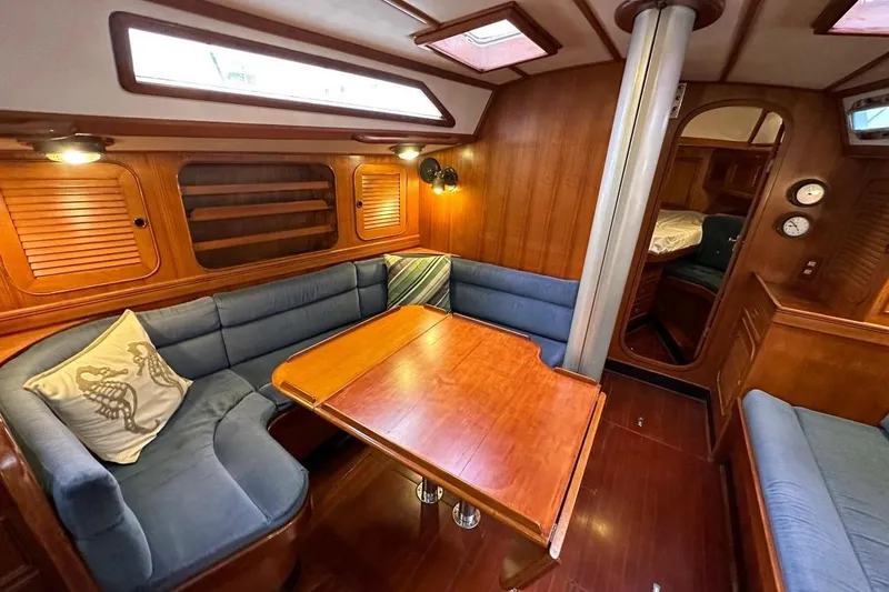 Slide: The Image of Interior of 1989 Hylas 44 yacht with wooden furnishings and blue seating. - 11