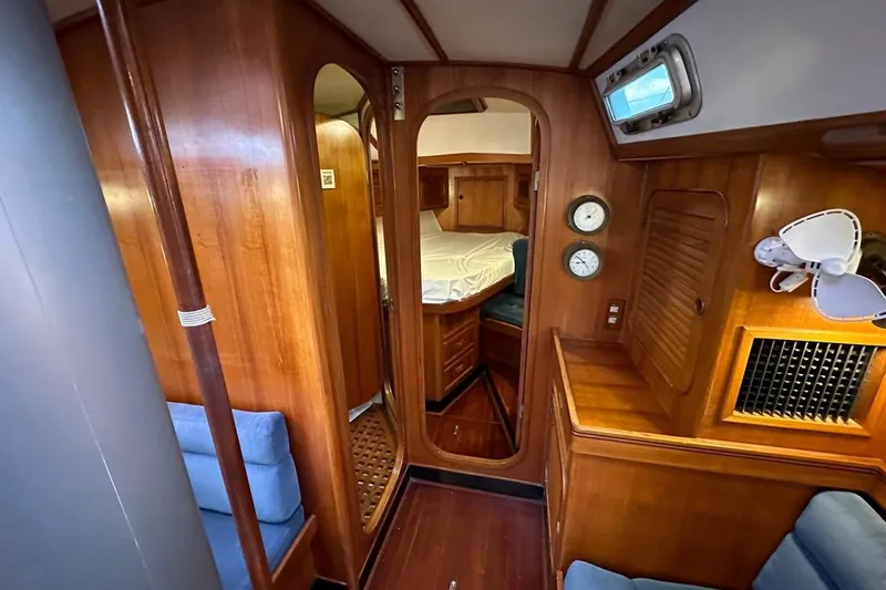 Slide: The Image of Interior of 1989 Hylas 44 yacht with wooden paneling and cozy cabin. - 16