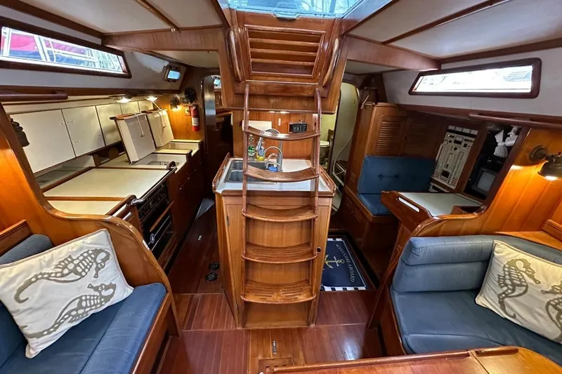 Slide: The Image of Interior of 1989 Hylas 44 yacht with wooden finish and cozy seating area. - 17