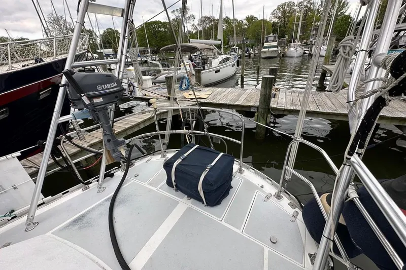 Slide: The Image of 1989 Hylas 44 sailboat docked at marina with Yamaha motor. - 18