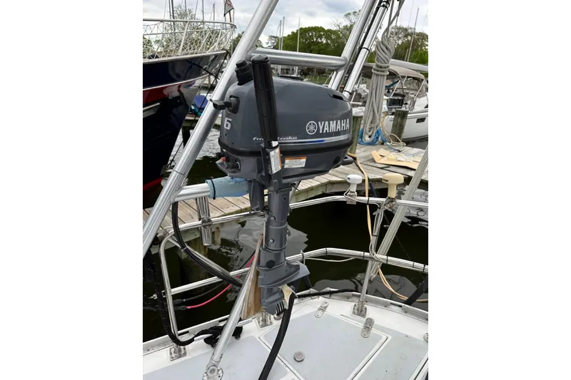 Slide: The Image of Yamaha outboard motor mounted on a 1989 Hylas 44 sailboat at a marina. - 19