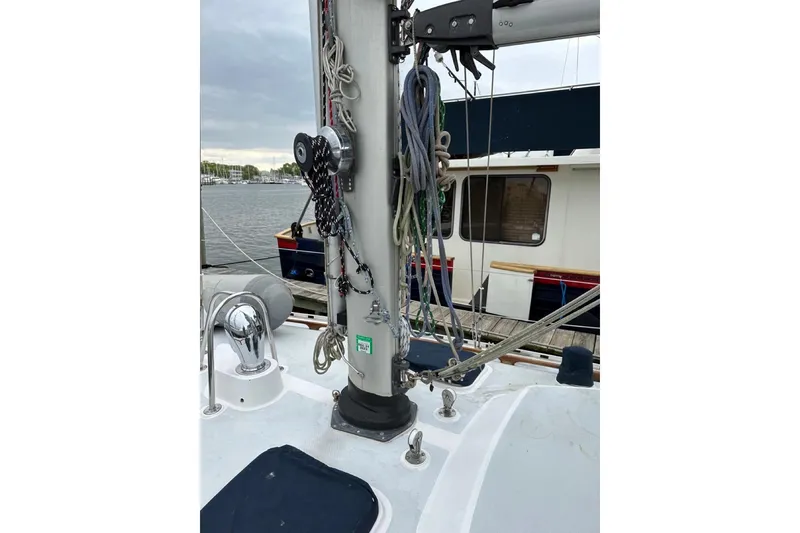Slide: The Image of Mast and rigging of a 1989 Hylas 44 sailboat docked at a marina. - 26