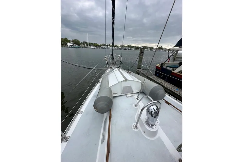Slide: The Image of Sailboat deck view of 1989 Hylas 44, docked under cloudy skies. - 27