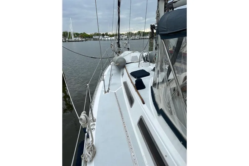 Slide: The Image of 1989 Hylas 44 sailboat docked, showcasing deck and rigging details. - 33