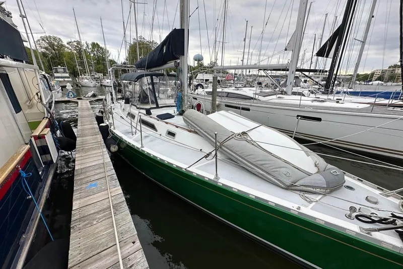 Slide: The Image of Sailboat docked at marina, Hylas 44 model, 1989, with green hull and covered deck. - 34
