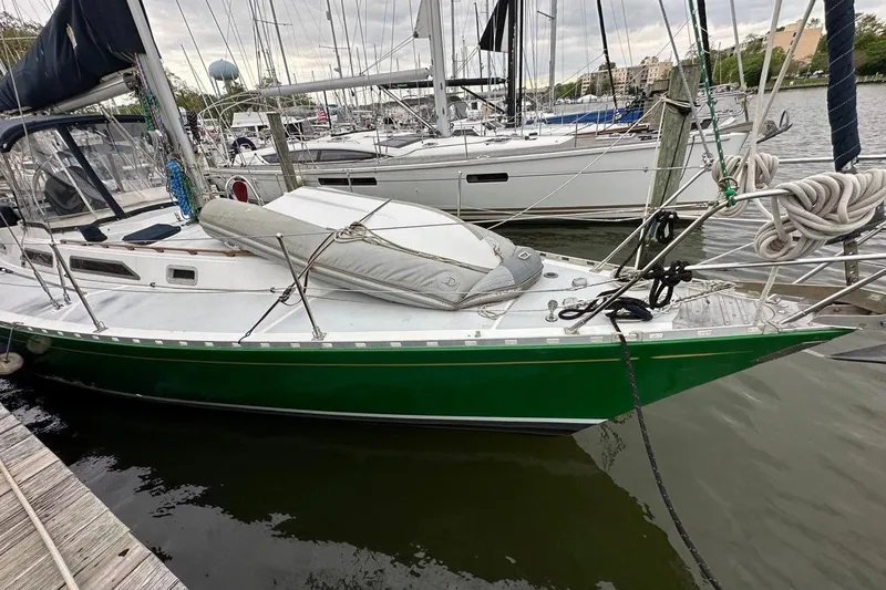 Slide: The Image of 1989 Hylas 44 sailboat with green hull docked in marina. - 5