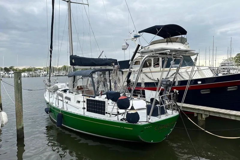 Slide: The Image of Green 1989 Hylas 44 sailboat docked at a marina under cloudy skies. - 6
