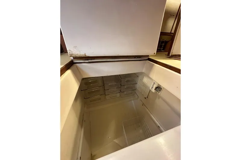 Slide: The Image of Open storage compartment inside a 1989 Hylas 44 yacht, featuring organized containers. - 7