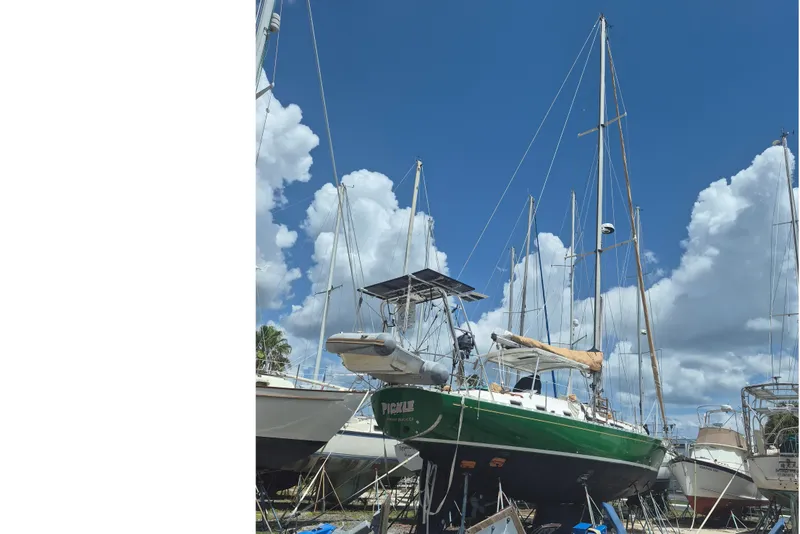 Slide: The Image of A 1989 Hylas 44 sailboat is on a dry dock under a blue sky. - 1