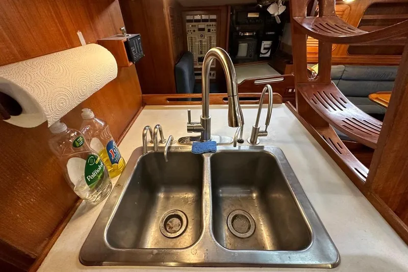 Slide: The Image of Galley sink area on a 1989 Hylas 44 yacht with dual faucets and dish soap. - 8