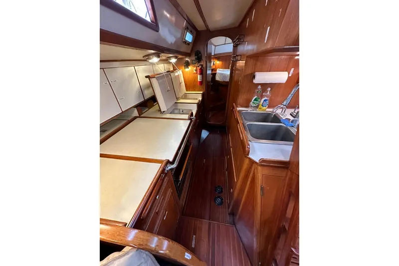 Slide: The Image of Interior of 1989 Hylas 44 yacht with wooden cabinetry and dual sinks. - 9