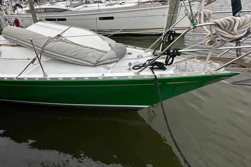 Slide: The Image of 1989 Hylas 44 sailboat with green hull docked in marina. - 5