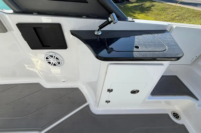 Slide: The Image of 2026 Monterey Elite 27 OB boat interior with sleek countertop and built-in speaker. - 11