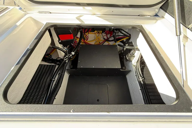 Slide: The Image of Open engine compartment of 2026 Monterey Elite 27 OB boat, showcasing wiring and components. - 12