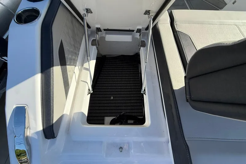 Slide: The Image of Open storage compartment on a 2026 Monterey Elite 27 OB boat. - 13