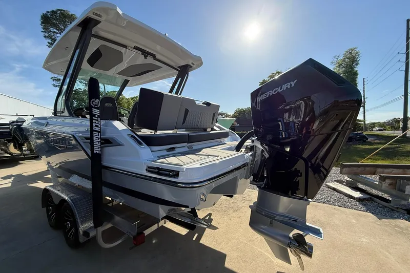Slide: The Image of 2026 Monterey Elite 27 OB boat with Mercury outboard engine on trailer, sunny day. - 3