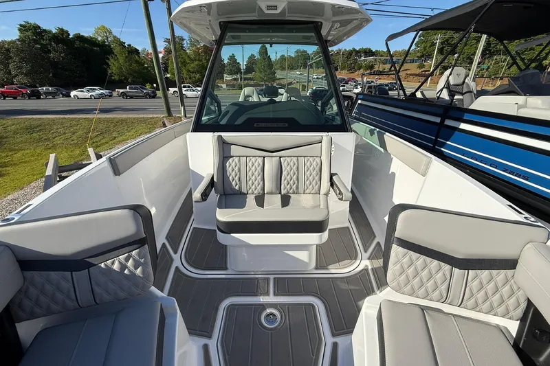 Slide: The Image of 2026 Monterey Elite 27 OB boat interior with gray seating and modern design. - 6