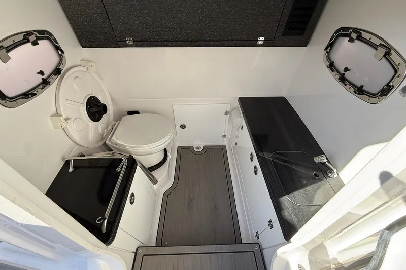 Slide: The Image of Interior of 2026 Monterey Elite 27 OB boat bathroom with modern fixtures. - 7