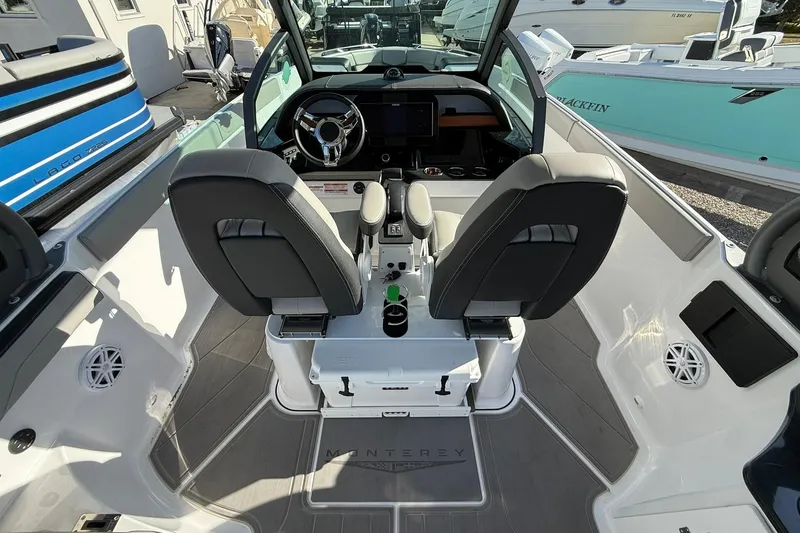 Slide: The Image of Interior view of 2026 Monterey Elite 27 OB boat with dual seats and modern dashboard. - 9