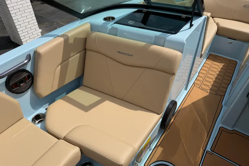 Slide: The Image of 2025 MasterCraft NXT22 boat interior with beige seating and modern design. - 11