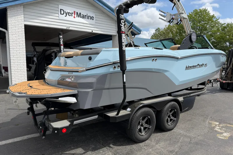 Slide: The Image of 2025 MasterCraft NXT22 boat on trailer at Dyer Marine dealership. - 5