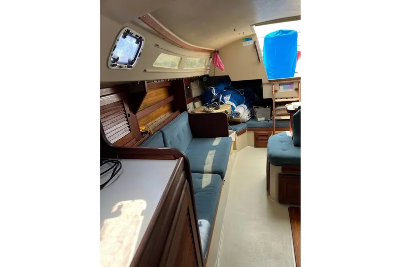 Slide: The Image of Interior of 1988 Catalina 30 MkII sailboat with blue seating and wooden accents. - 5