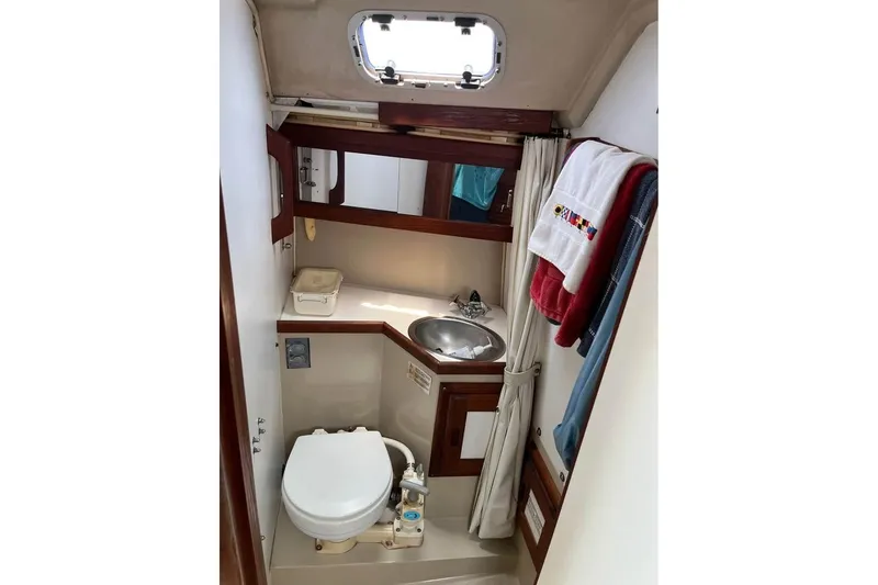 Slide: The Image of 1988 Catalina 30 MkII yacht bathroom with sink, toilet, and storage. - 6