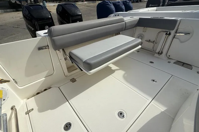 Slide: The Image of 2023 Boston Whaler 330 Outrage boat interior with foldable seating and Mercury engines. - 3