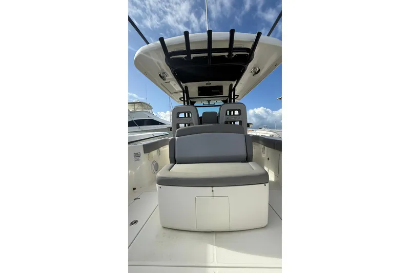 Slide: The Image of 2023 Boston Whaler 330 Outrage boat interior with seating and overhead canopy. - 4