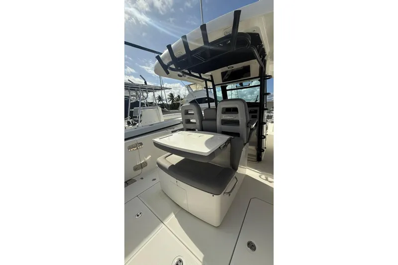 Slide: The Image of 2023 Boston Whaler 330 Outrage boat interior with seating and storage. - 5