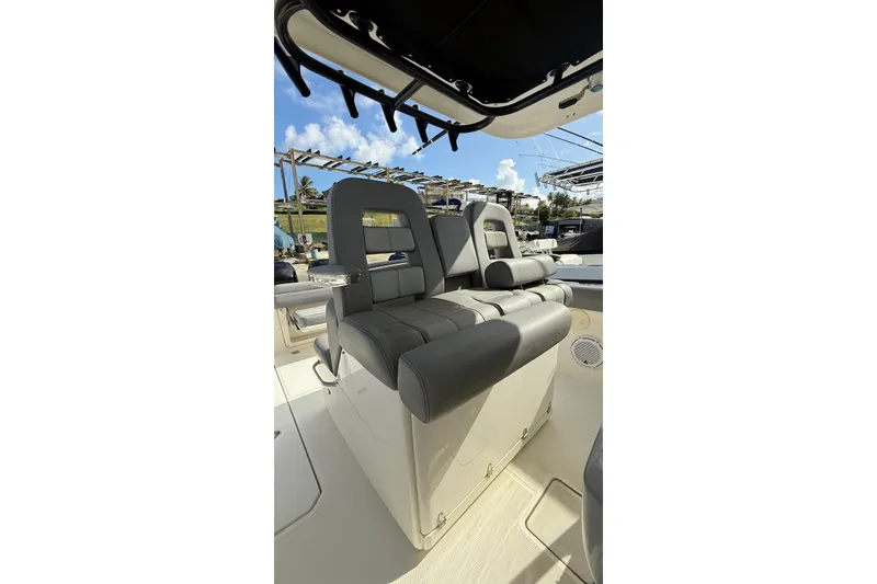 Slide: The Image of 2023 Boston Whaler 330 Outrage boat seats under canopy, showcasing luxury and comfort. - 7