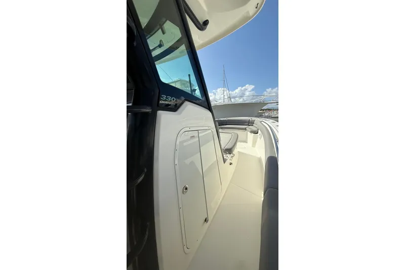 Slide: The Image of 2023 Boston Whaler 330 Outrage boat deck with seating and clear sky. - 8