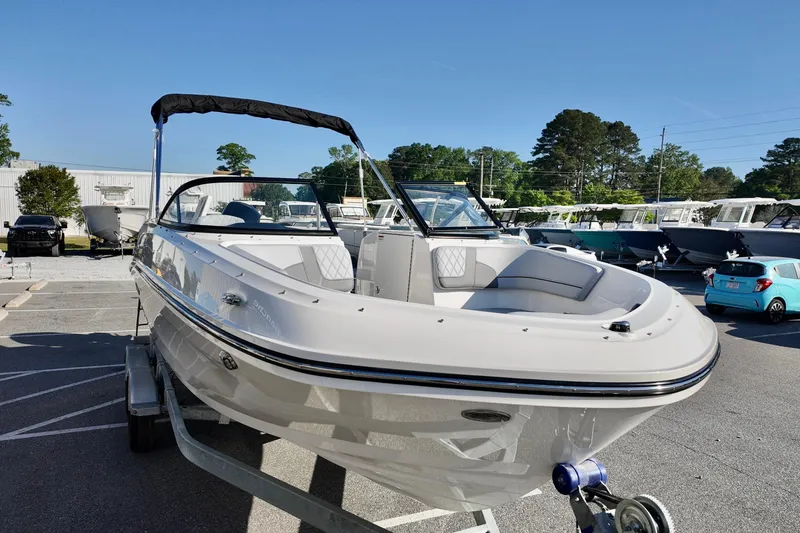 Slide: The Image of 2026 Bayliner VR6 Bowrider OB on trailer in a marina parking lot. - 10