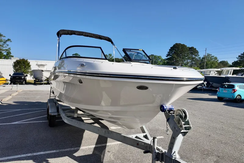 Slide: The Image of 2026 Bayliner VR6 Bowrider OB on trailer in parking lot, sunny day. - 11