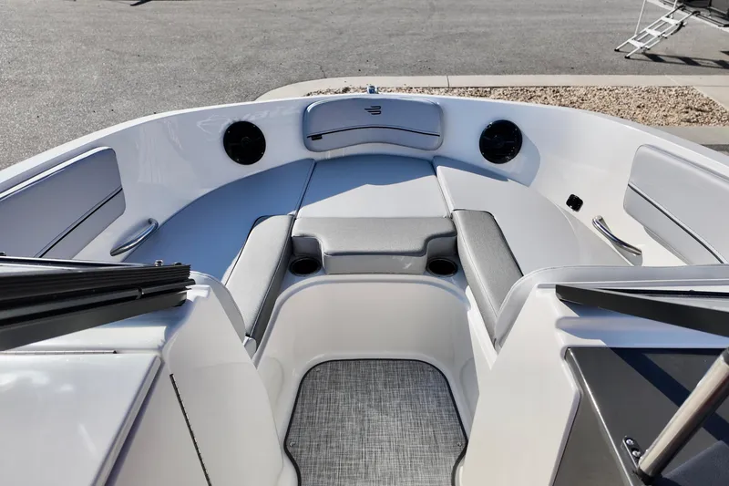 Slide: The Image of 2026 Bayliner VR6 Bowrider OB interior with cushioned seating and cup holders. - 13