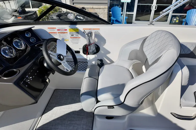 Slide: The Image of Interior of 2026 Bayliner VR6 Bowrider OB, featuring sleek steering and modern seating. - 24