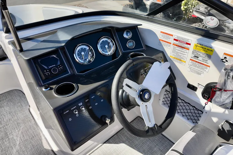 Slide: The Image of 2026 Bayliner VR6 Bowrider OB dashboard with steering wheel and control panel. - 25