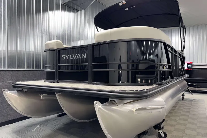 Slide: The Image of 2026 Sylvan Mirage X1 LZ DH pontoon boat in showroom, sleek black design. - 19