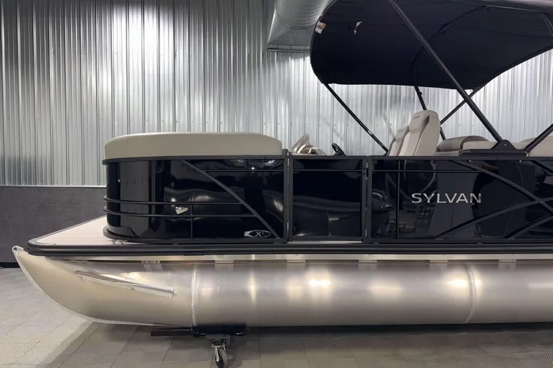 Slide: The Image of 2026 Sylvan Mirage X1 LZ DH pontoon boat in showroom, sleek black design. - 20