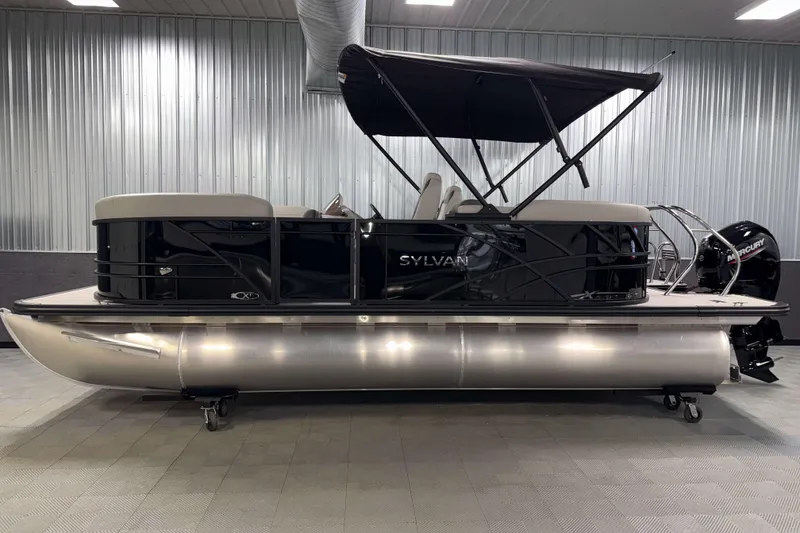 Slide: The Image of 2026 Sylvan Mirage X1 LZ DH pontoon boat in showroom, featuring sleek design and modern amenities. - 21