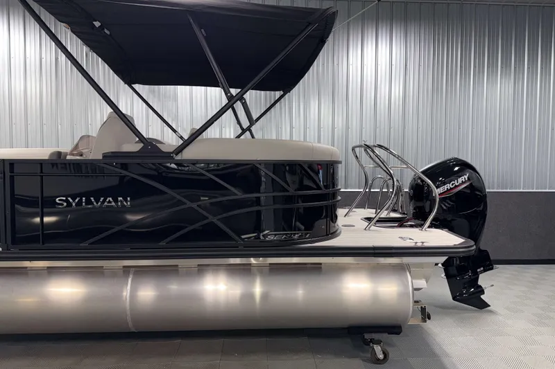 Slide: The Image of 2026 Sylvan Mirage X1 LZ DH pontoon boat with Mercury outboard motor in showroom. - 22