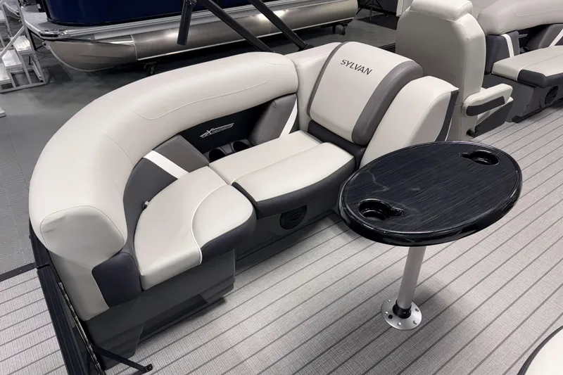 Slide: The Image of Luxurious seating on 2026 Sylvan Mirage X1 LZ DH pontoon boat with sleek table design. - 4